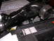 2007 Mazda 3 - Close-up of the engine bay of a 2007 Mazda 3, showing the intake pipe and radiator.