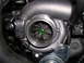 2007 Mazda 3 - A turbocharger with a metal tag showing part numbers and markings.