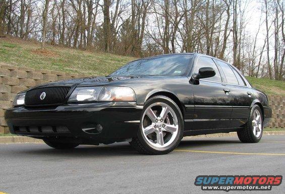 Black 2003 Mercury Marauder sedan, front 3/4 view, chrome wheels, parked on asphalt