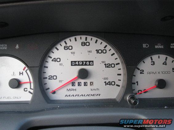 Dashboard gauges with 'Marauder' text, odometer showing 049766