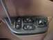 1996 Ford Bronco - A screwdriver is used to remove the door lock and window control panel from a vehicle's interior door.