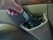 1996 Ford Bronco - A hand is shown removing a piece of black plastic trim from a car's interior door panel.