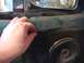 1996 Ford Bronco - Interior door panel with a speaker is visible, with a hand interacting with the panel edge.