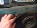 1996 Ford Bronco - Close-up of a hand removing trim from a vehicle's interior door panel, revealing a speaker.