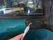 1996 Ford Bronco - A hand uses a socket wrench to remove a side mirror from a teal vehicle, which has a 'Police Interceptor' sticker on the window.