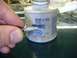 1996 Ford Bronco - A bolt is coated with anti-seize lubricant from a can of Permatex.