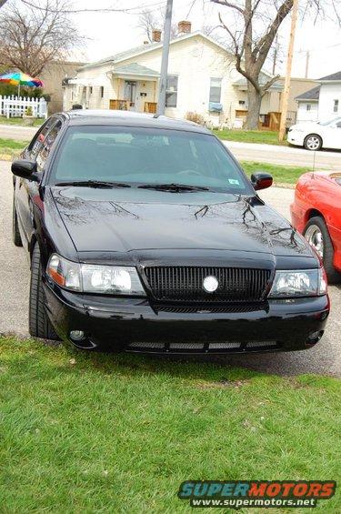 2003 Mercury Marauder front view, parked on grass next to a red car