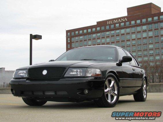 Black 2003 Mercury Marauder parked in front of a brick building with 'HUMANA' signage