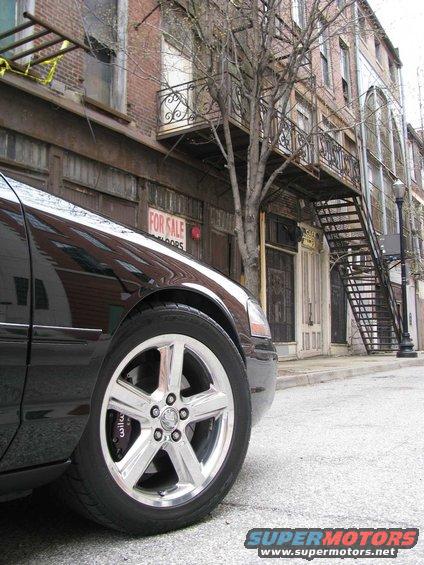 Black 2003 Mercury Marauder front fender and chrome wheel