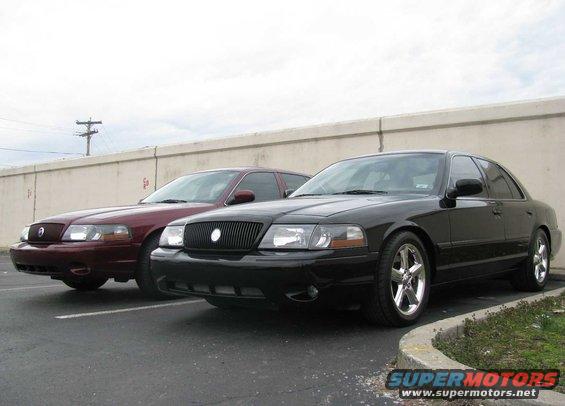 Black 2003 Mercury Marauder in front of a maroon one, parked on asphalt