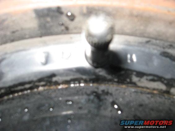 Close-up of a metal part with visible numbers '3 12' and '14'