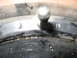 1964 Chevrolet Corvette - Close-up of a metal part, possibly a wheel hub or brake drum, with visible markings.
