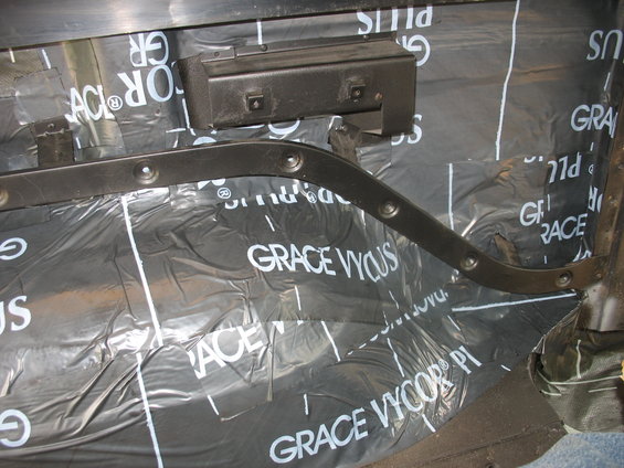 close-up of black sound dampening material with 'GRACE VYCOR' text installed on vehicle interior panels