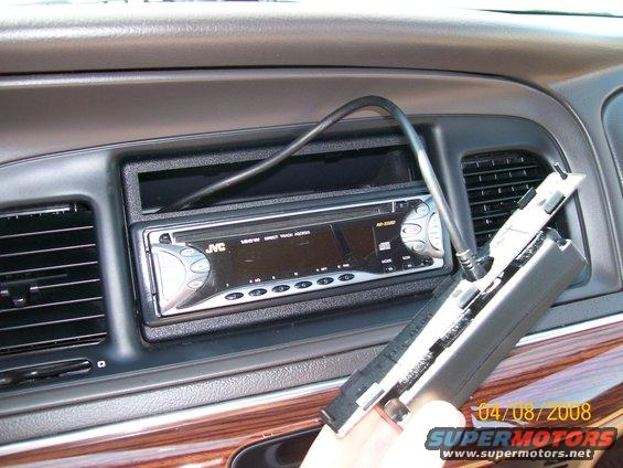 Dashboard of a 1995 Mercury Grand Marquis with a JVC stereo and wood trim