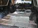 1978 Ford Bronco - The interior of an SUV is being worked on, with sound-deadening material installed on the floor and door panels.