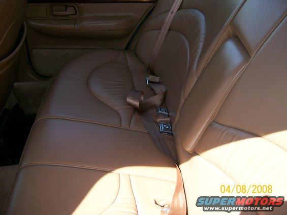 Rear leather seats and seatbelts in a car interior. Date stamp 04/08/2008