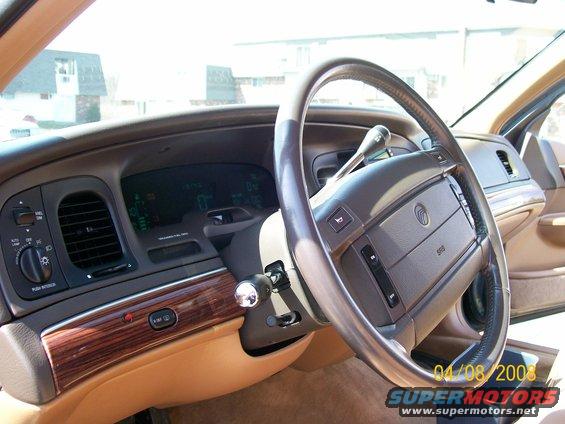 1995 Mercury Grand Marquis interior dashboard with wood trim and digital gauges
