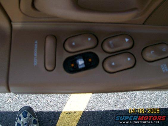 Car door panel with window lock and power window controls. Text reads 'WINDOW LOCK' and 'DOOR LOCK'