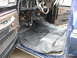 1978 Ford Bronco - The interior of a 1978 Ford Bronco shows new carpet installation with exposed wiring and a worn dashboard.