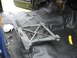 1978 Ford Bronco - Jack mechanism and wiring visible inside a vehicle with a new black floor liner installed.