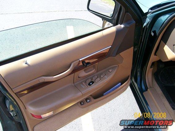 Tan car door panel with wood trim, power window controls, and a side mirror. Date stamp reads 04/08/2008