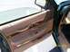 1995 Mercury Grand Marquis - The interior door panel of a 1995 Mercury Grand Marquis shows tan upholstery and wood accents.