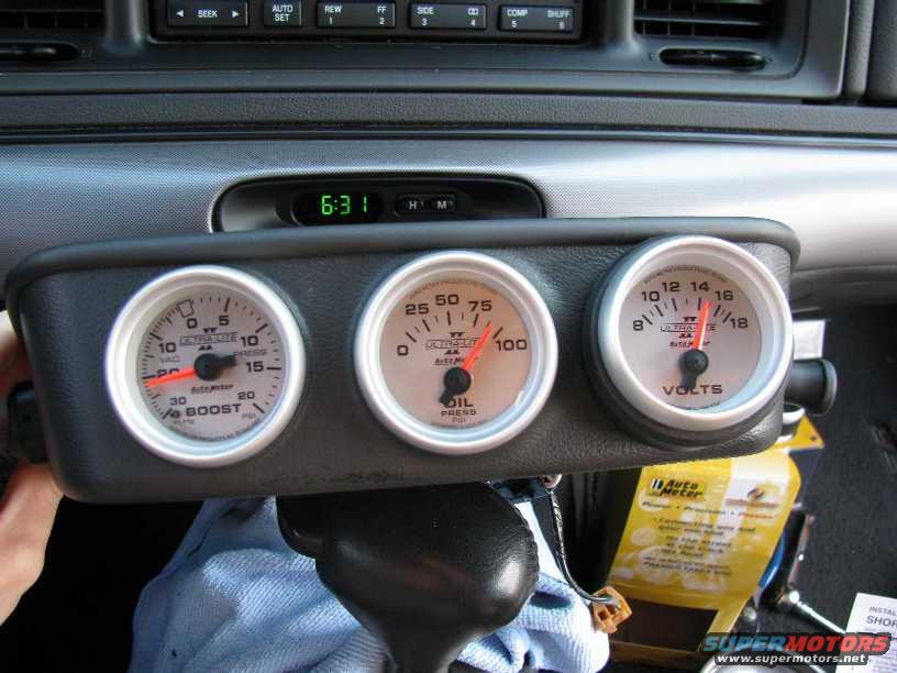 Three Auto Meter gauges: Boost, Oil Pressure, and Volts, mounted on a dashboard