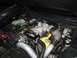 2003 Mercury Marauder - Close-up of a modified V8 engine, a prominent supercharger and bright yellow valve covers.