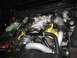 2003 Mercury Marauder - Engine bay a supercharger and yellow valve covers. Some text is visible on the engine block.