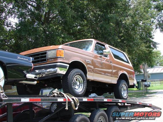 1989 Ford Bronco on a car hauler, side view