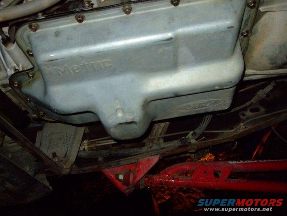 Underside view of a Ford transmission oil pan with 'Metric' embossed on it