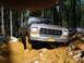 1978 Ford Bronco - This 1978 Ford Bronco is navigating a challenging muddy path in a forest.