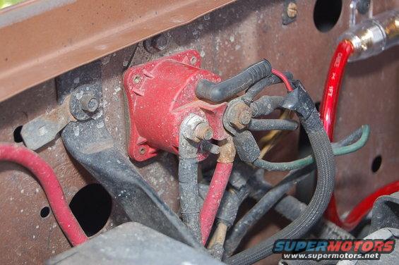 Engine bay wiring with red starter solenoid and red battery cable