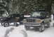 1993 Ford Bronco - Two off-road vehicles are parked in a snowy forest, with a person attending to the pickup truck.