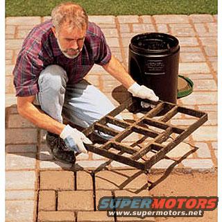 Man with concrete paver mold on brick patio