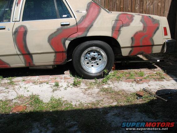 1985 Ford Crown Victoria LTD with custom tan and red paint job, rear wheel visible
