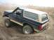 1990 Ford Bronco - This lifted Ford Bronco is navigating a muddy trail with a snorkel installed.