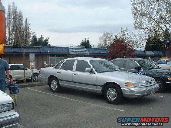 Silver sedan parked in a lot, 3q-front view. Appears to be a 1990s model