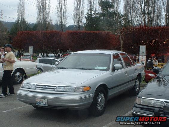 Silver sedan parked in a lot. License plate 680-SCB