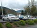 1987 Ford Crown Victoria LTD - Several police cars are parked in a lot with a fire ladder truck visible to the left.