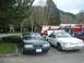 1987 Ford Crown Victoria LTD - Two Ford Mustangs and a fire truck are parked at an outdoor event.