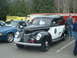 1987 Ford Crown Victoria LTD - A classic 1940 Ford Police Car is displayed next to other vehicles at an outdoor event.