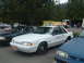 1987 Ford Crown Victoria LTD - A white police car with "Oregon State Police" text on the door is parked at an outdoor event with other vehicles and a fire truck.