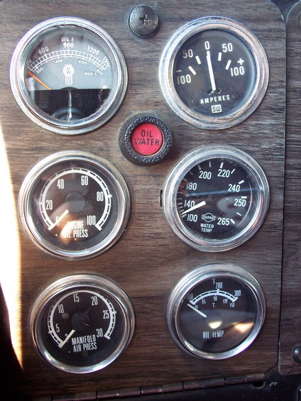 Dashboard gauges with Kenworth logo, oil pressure, water temp, oil temp, and air pressure readings