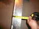 1996 Ford Probe - Measuring tape shows 2 inches on a metal sheet.