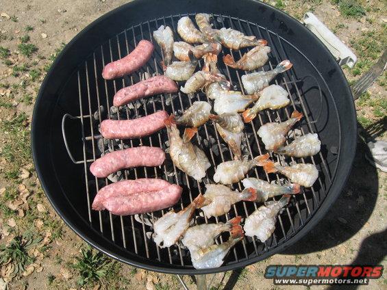 Sausages and shrimp grilling outdoors