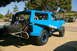 1986 Ford Bronco - This modified 1986 Ford Bronco features an off-road roll cage and a prominent spare tire carrier on the rear.