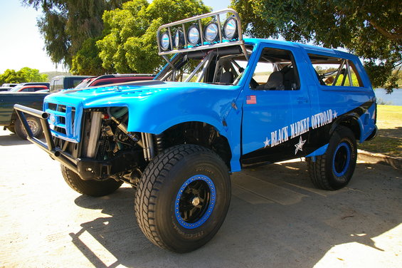 Blue off-road Bronco with "Black Market Offroad" graphics and light bar