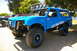 1986 Ford Bronco - Customized blue off-road vehicle with "Black Market Offroad" branding and a prominent light bar on the roof.