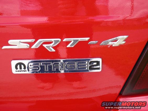 Close-up of SRT-4 and Stage 2 Mopar badges on a red car